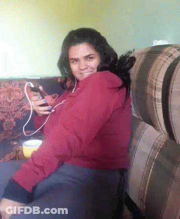 Woman In Red Jacket Sitting On Couch GIF