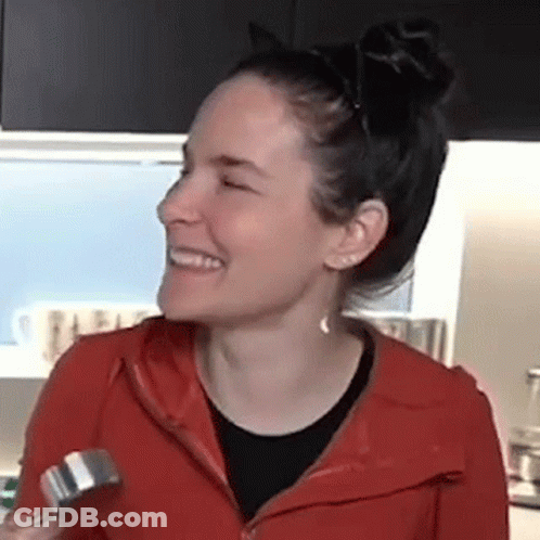 Woman In Red Jacket Smiling Holding Dumbbell GIF
