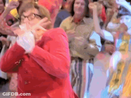 Woman In Red Jacket Standing Before Crowd GIF