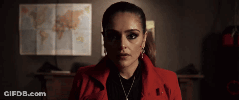Woman In Red Jacket Standing In Front Of World Map GIF