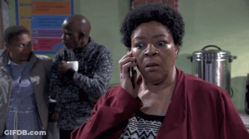Woman In Red Jacket Talking On Phone GIF