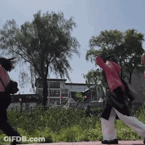 Woman In Red Jacket Walking Past Korean Sign GIF