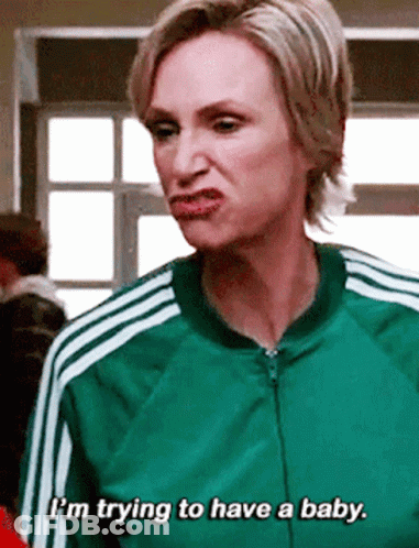 Woman In Red Jacket With Yellow Stripes Next To Man In Suit GIF