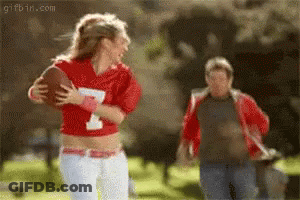 Woman In Red Jersey Number 1 Holding Football GIF