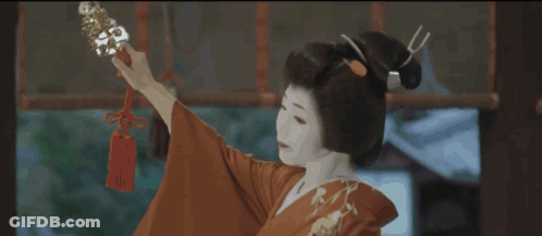 Woman In Red Kimono Holding Sword With Red Tag GIF