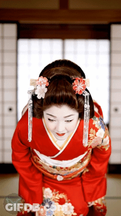 Woman In Red Kimono With Flowers Bowing Head GIF