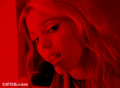 Woman In Red Light Holding Microphone GIF
