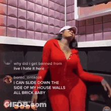 Woman In Red Outfit Dancing In Front Of Brick Wall GIF