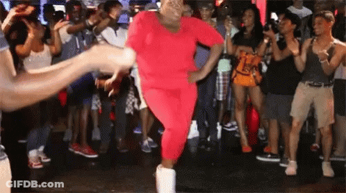 Woman In Red Outfit Dancing In Front Of Crowd GIF