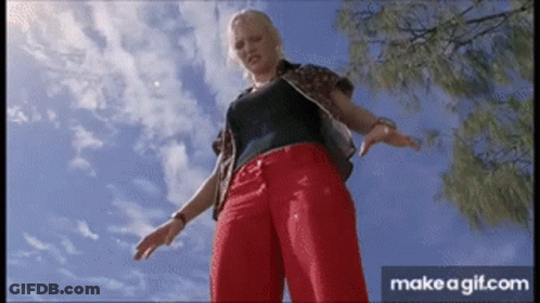 Woman In Red Pants And Black Shirt Under Blue Sky GIF