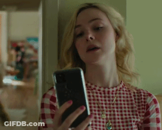 Woman In Red Plaid Shirt Looking At Cell Phone GIF