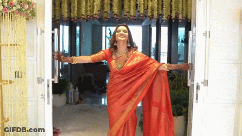Woman In Red Saree Opens Door GIF