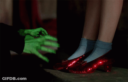 Woman In Red Sequined Shoes Next To Witch Hand GIF