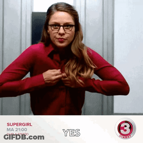 Woman In Red Shirt And Glasses Holding Chest Saying Yes GIF