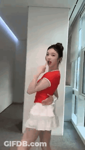 Woman In Red Shirt And White Skirt Dancing GIF