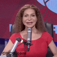 Woman In Red Shirt At Microphone Smiling GIF