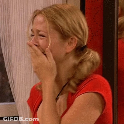 Woman In Red Shirt Covering Face With Hands GIF