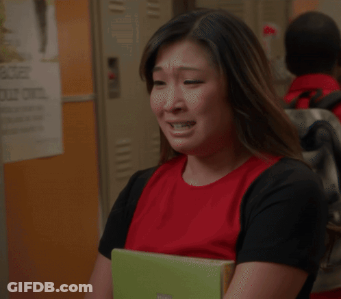 Woman In Red Shirt Crying And Covering Eyes GIF