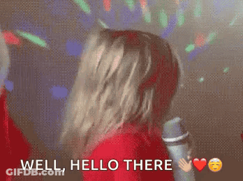 Woman In Red Shirt Dancing At Microphone Saying Well Hello There GIF