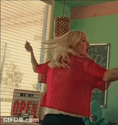 Woman In Red Shirt Dancing In Diner Window GIF