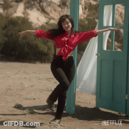 Woman In Red Shirt Dancing In Front Of Netflix Door GIF