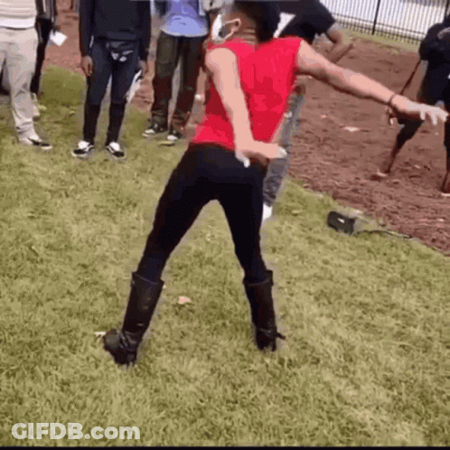 Woman In Red Shirt Dancing In Grass GIF