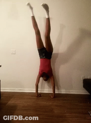 Woman In Red Shirt Doing Handstand GIF