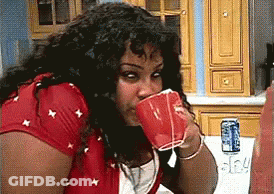 Woman In Red Shirt Drinking From Cup GIF