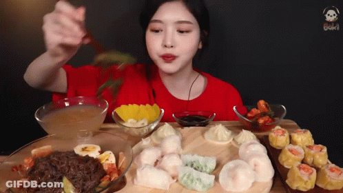 Woman In Red Shirt Eating With Chopsticks GIF