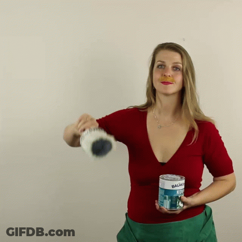 Woman In Red Shirt Holding Balsamo Kol GIF