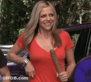 Woman In Red Shirt Holding Bat And Smiling GIF