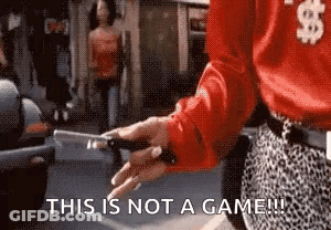 Woman In Red Shirt Holding Knife Saying This Is Not A Game GIF