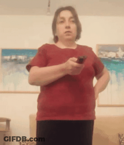 Woman In Red Shirt Holding Remote Control GIF