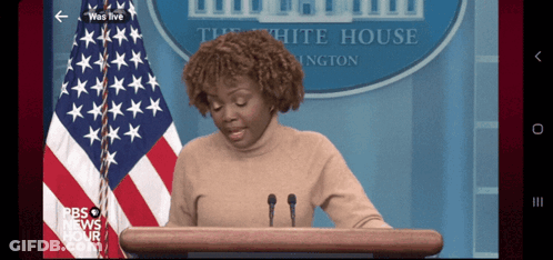 Woman In Red Shirt In Front Of American Flag GIF