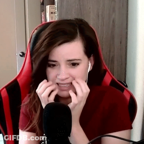 Woman In Red Shirt Making Funny Face At Microphone GIF