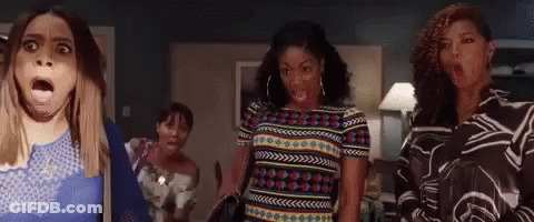 Woman In Red Shirt Making Funny Face In Crowd GIF