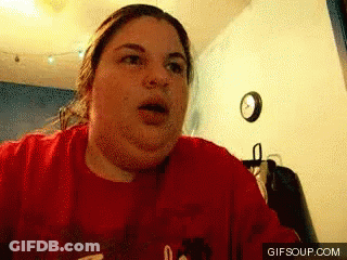 Woman In Red Shirt Making Funny Face In Front Of Clock GIF