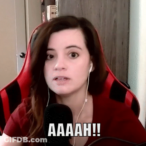 Woman In Red Shirt Saying Aaah At Microphone GIF