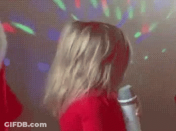Woman In Red Shirt Singing Into Microphone GIF