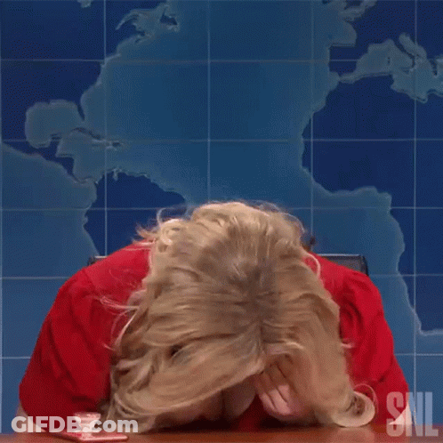 Woman In Red Shirt Sitting At Table With SNL Logo GIF