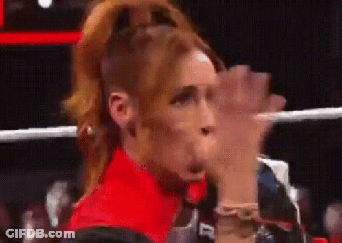 Woman In Red Shirt Sitting In Ring With Hands Up GIF
