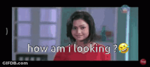 Woman In Red Shirt Smiling Asking How Am I Looking GIF