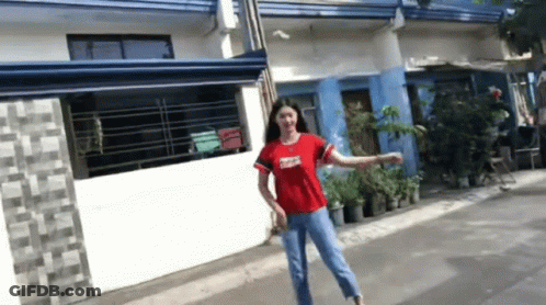Woman In Red Shirt Standing On Street GIF
