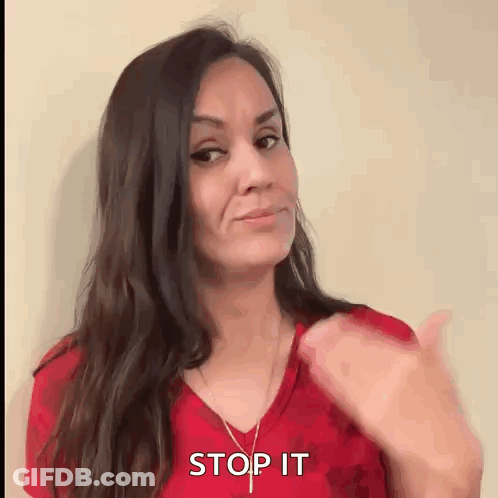 Woman In Red Shirt Thumbs Up Saying Stop It GIF