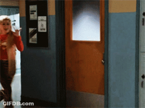 Woman In Red Shirt Walking To Wooden Door GIF