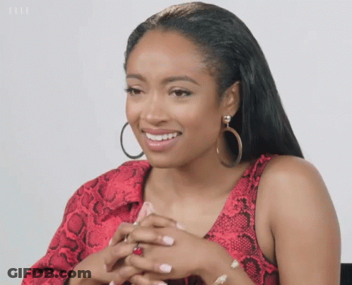 Woman In Red Snakeskin Top And Hoop Earrings GIF