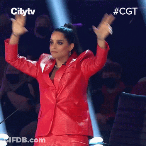 Woman In Red Suit Applauding In Front Of Citytv Logo GIF