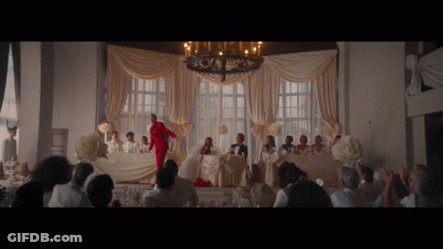 Woman In Red Suit At Wedding Reception GIF