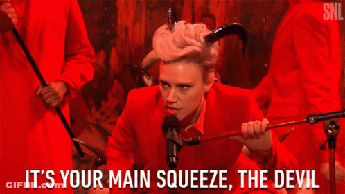 Woman In Red Suit Holding Whip Says It's Your Main Squeeze The Devil GIF