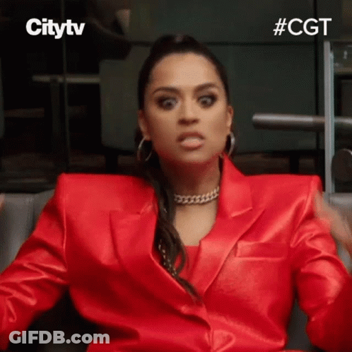 Woman In Red Suit Making Face GIF